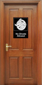 A timber door with a 'No ghosts allowed' sign on it.