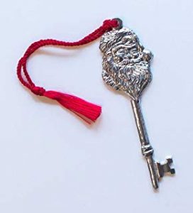 A metal key with Santa's face on and a red tassle.